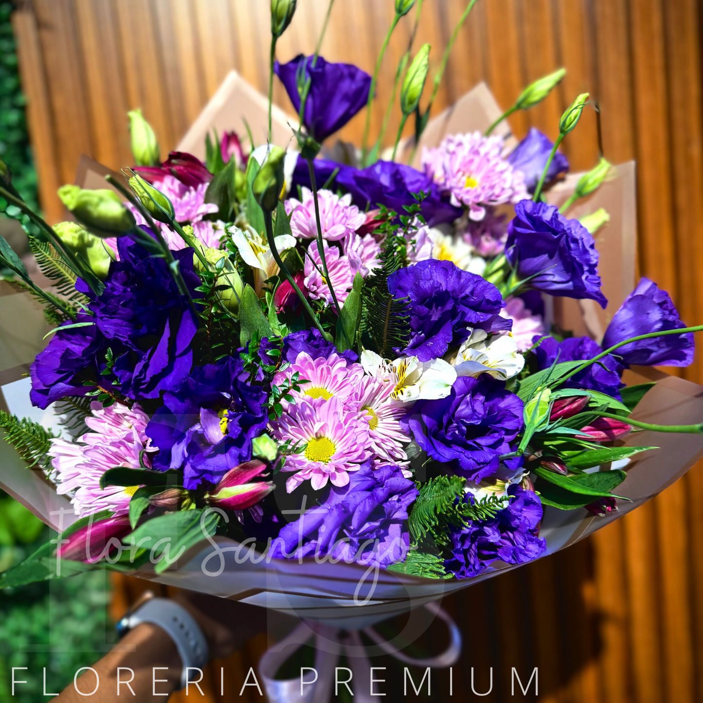 Ramo con lisianthus y margaritas lilas, envuelto para regalo.